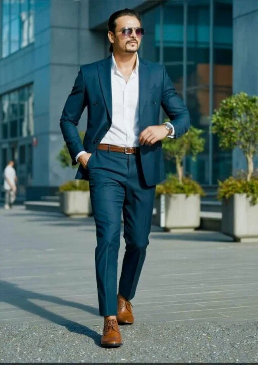 Ahmed Afridi walking outside a glass-fronted building
