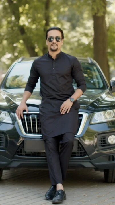 Ahmed Afridi standing beside a vehicle in a black shirt