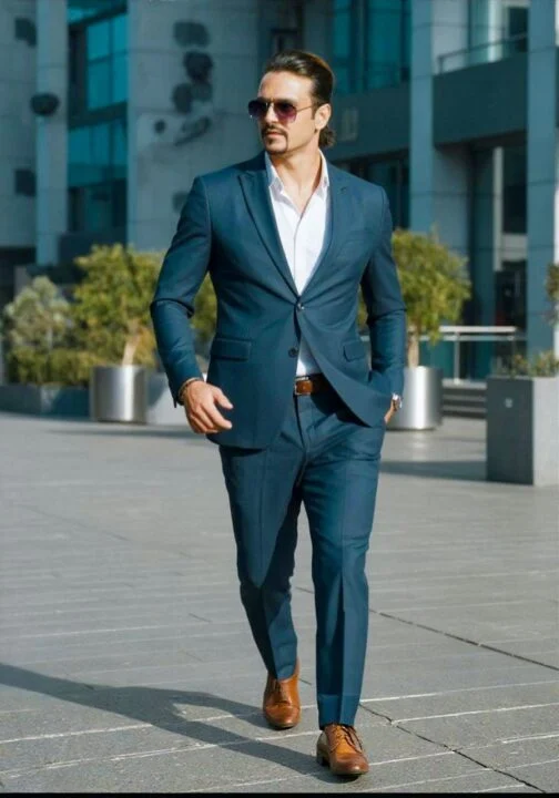 Ahmed Afridi walking outdoors in a navy blazer